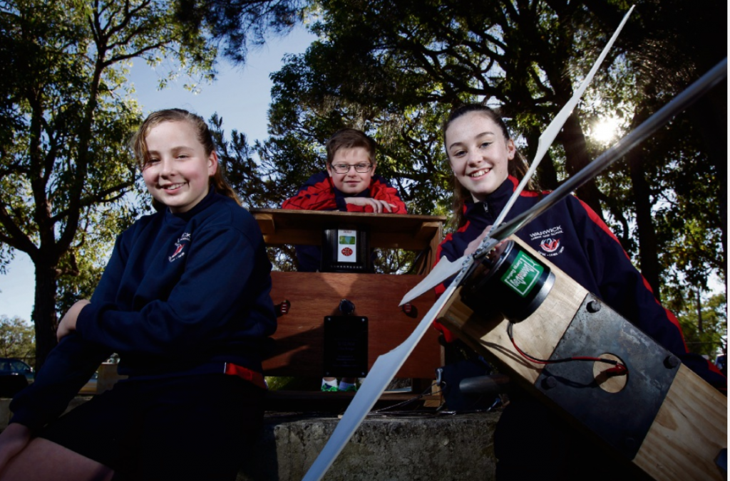Warwick Senior High School students Charlotte Jolley (12), Blake Bramwell (12) and Brooklyn Lowrie (12) with the wind turbine. Picture: Marie Nirme d470902